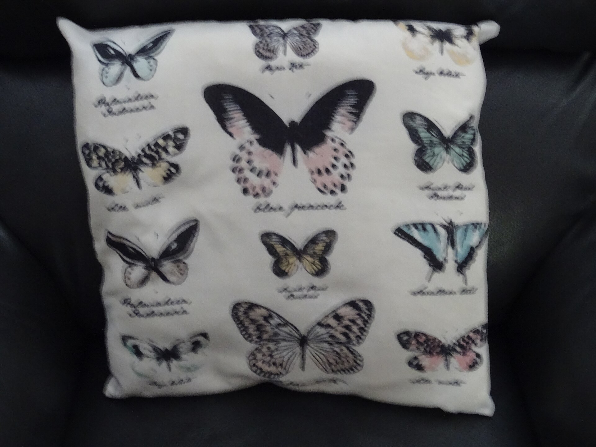 Decorative textile cushion with butterfly motifs