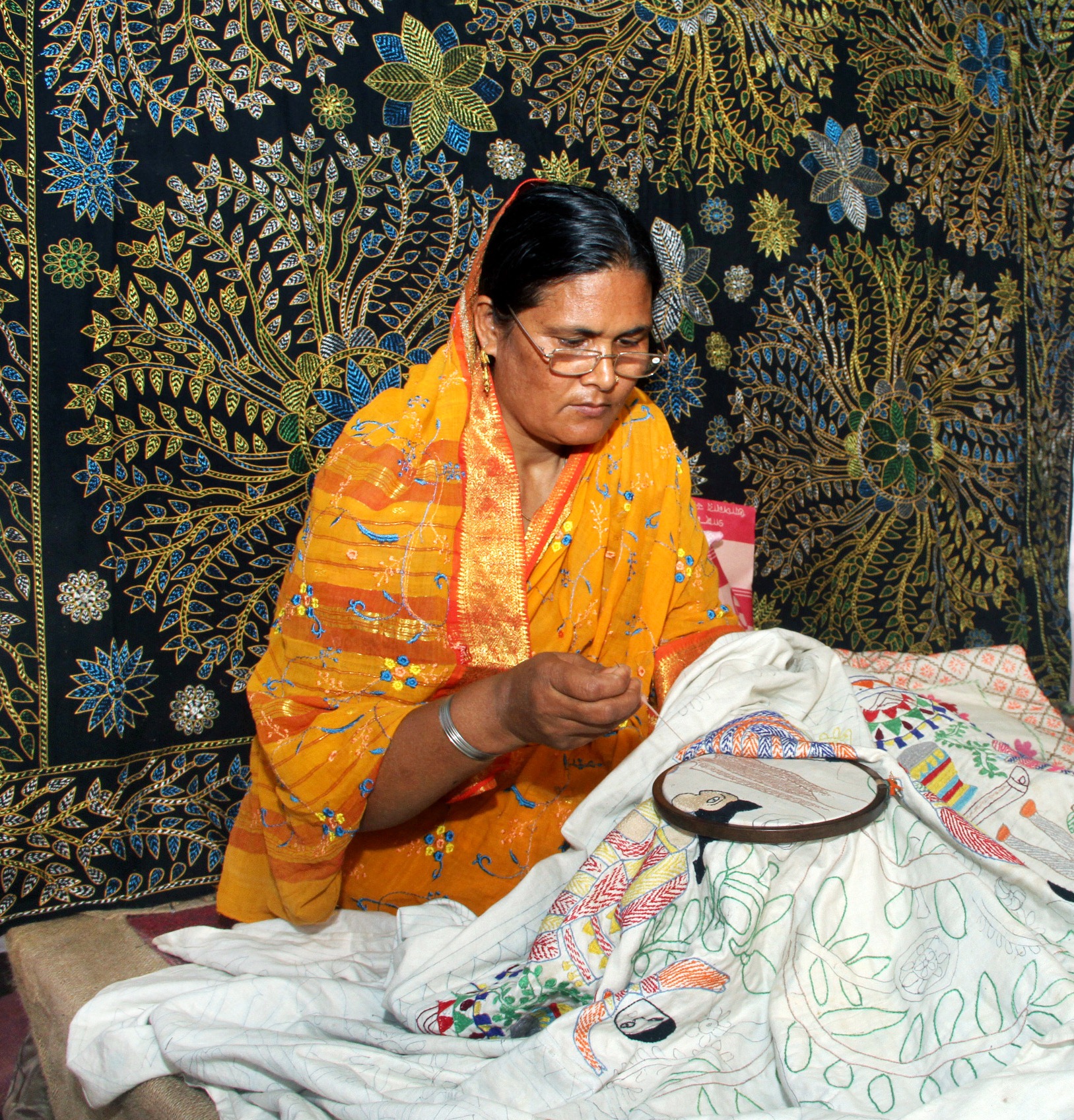 Nakshi kantha craftswoman working on embroidered cloth